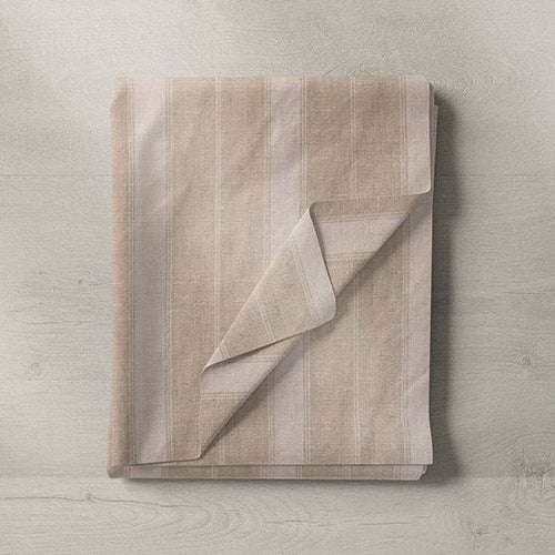 Brown and beige fabrics for curtains and upholstery in earthy, neutral tones.