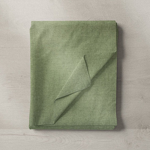 Close-up of sage green cotton upholstery fabric with soft texture