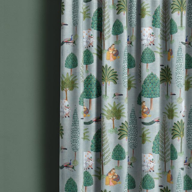 Duck egg blue-green linen curtain fabric hanging in a softly lit contemporary room