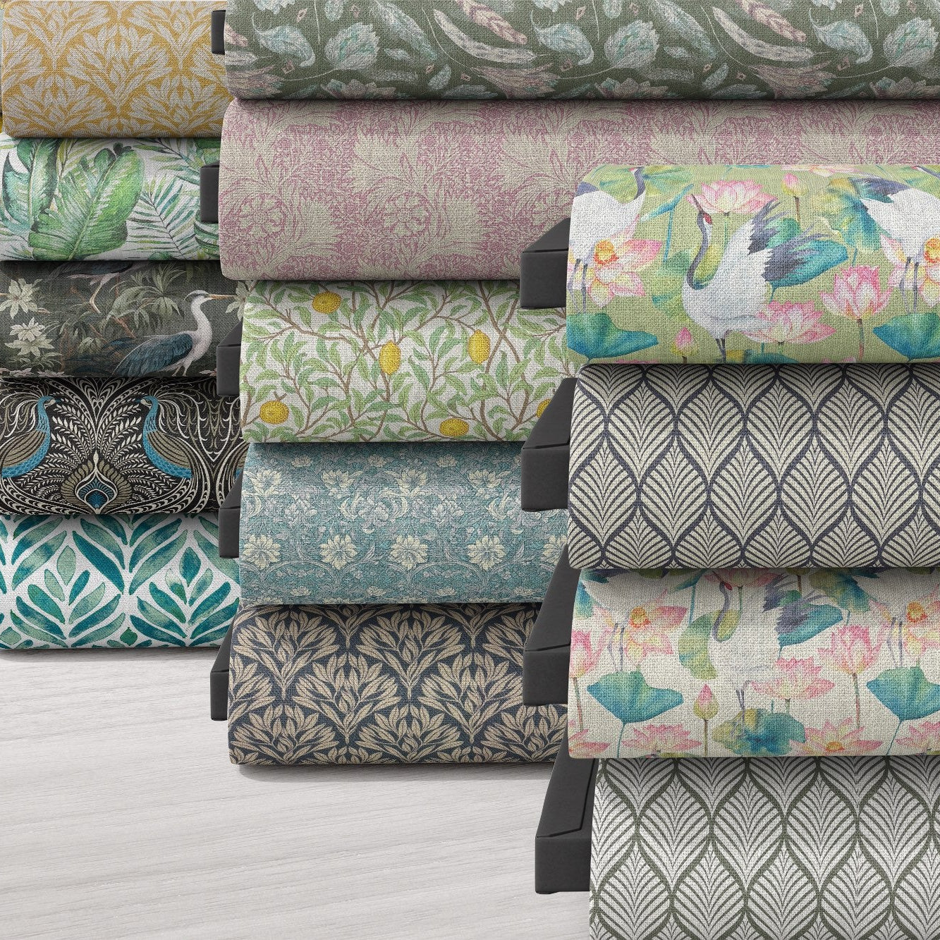 Stack of patterned and plain fabrics by the metre including florals, geometrics and textured upholstery materials