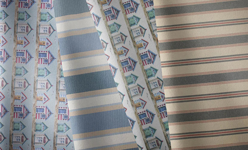 Coastal-inspired fabrics in blue, neutral and nautical prints for curtains and upholstery.