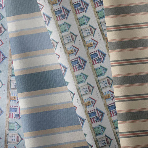 Coastal-inspired fabrics in blue, neutral and nautical prints for curtains and upholstery.