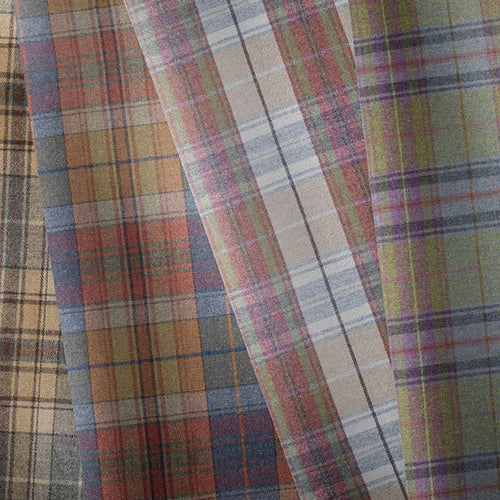 Tartan fabric in traditional plaid designs for upholstery and curtains.