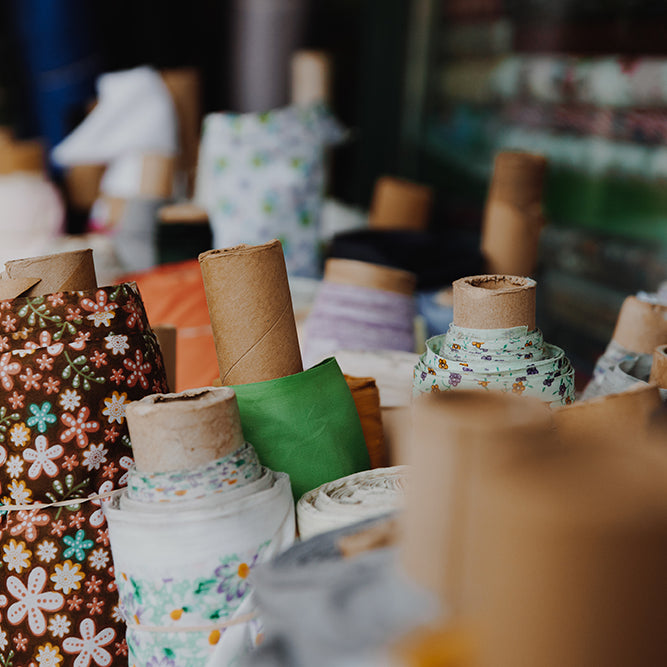 Discount curtain fabrics in patterned and plain styles, available by the metre.