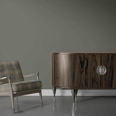 Green plaid Alford upholstery fabric used on a mid-century armchair in a modern room interior
