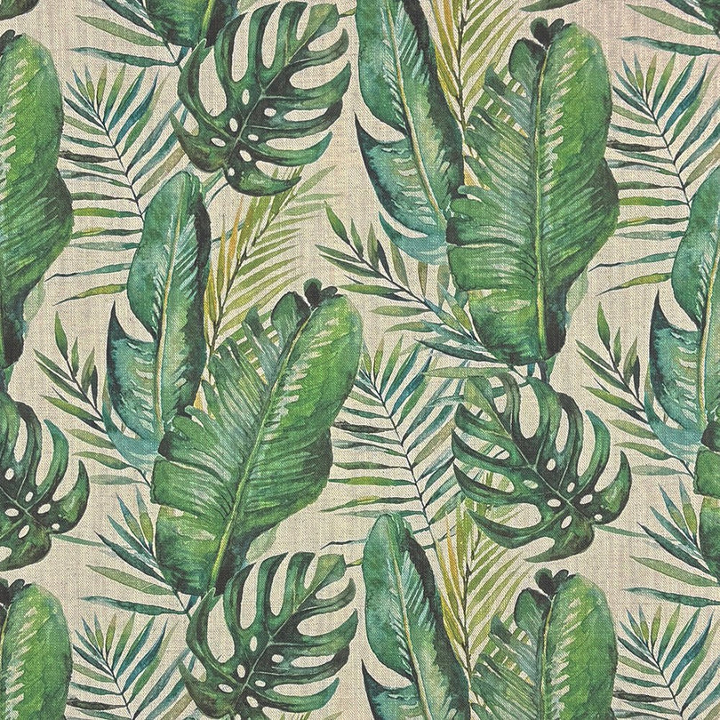Close-up of Amazon Leaf green upholstery fabric with large painted jungle leaves on a natural background