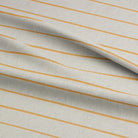 Draped Anfo Ochre striped curtain fabric, emphasizing its smooth drape and warm ochre tones.