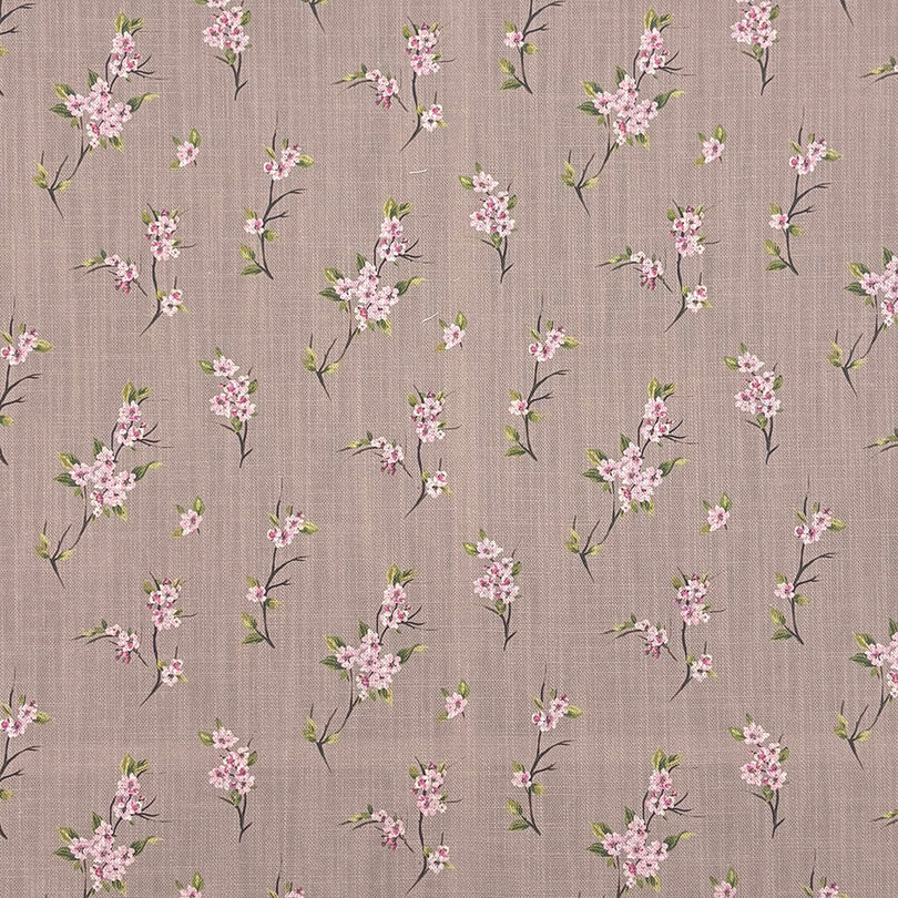 Close-up of Apple Blossom linen curtain fabric in Natural with pink floral design on a soft taupe background