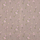 Close-up of Apple Blossom linen curtain fabric in Natural with pink floral design on a soft taupe background