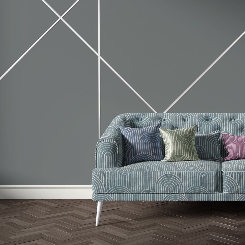 Blue velvet sofa upholstered in Archway Azure upholstery fabric with bold Art Deco arches in white