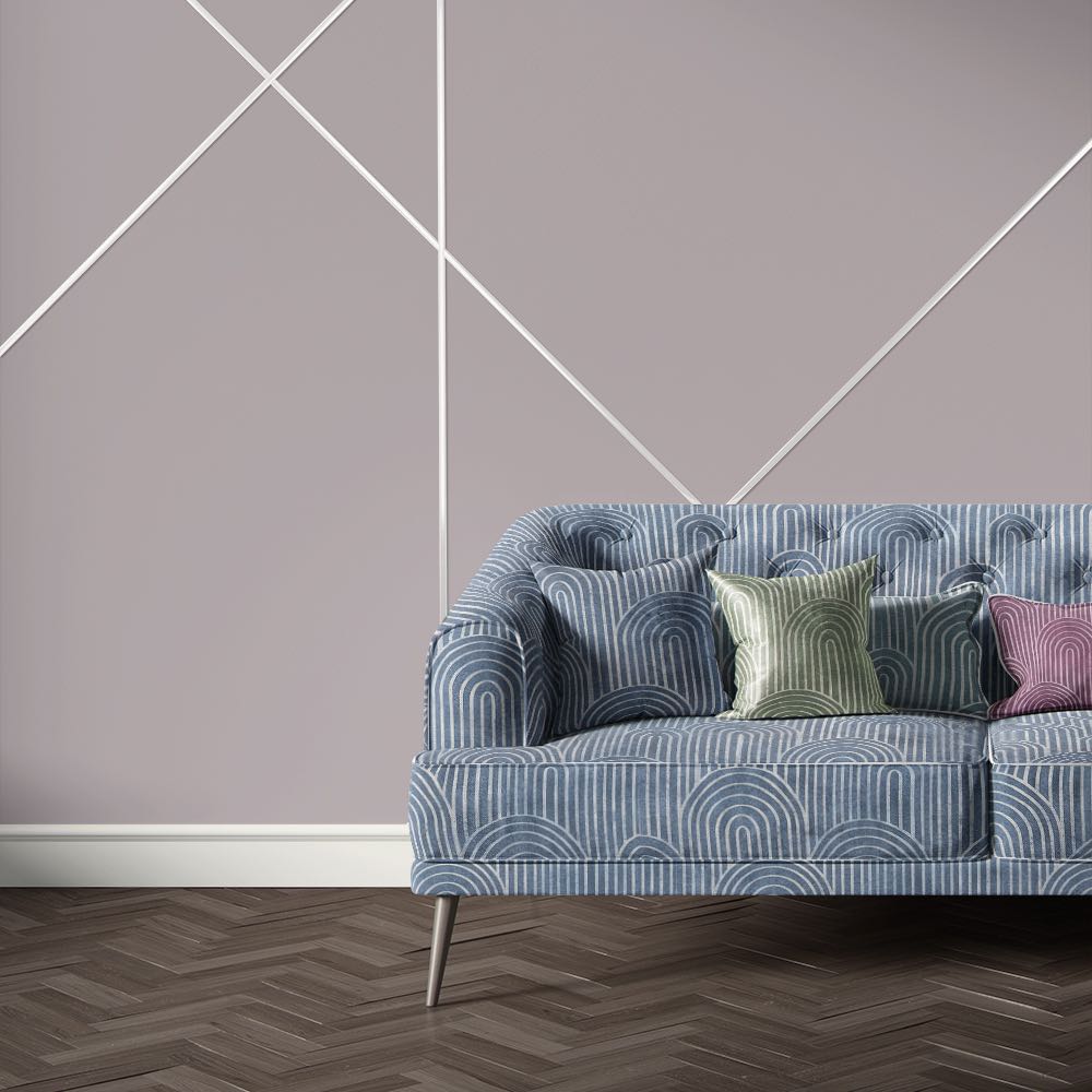 Dark blue velvet sofa upholstered in Archway Ink upholstery fabric with Art Deco style geometric arch pattern