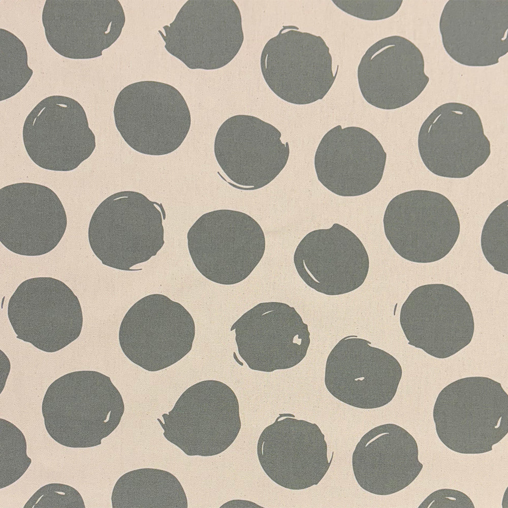 Arno Spot Fennel curtain fabric, featuring a fresh green polka dot print for natural décor.