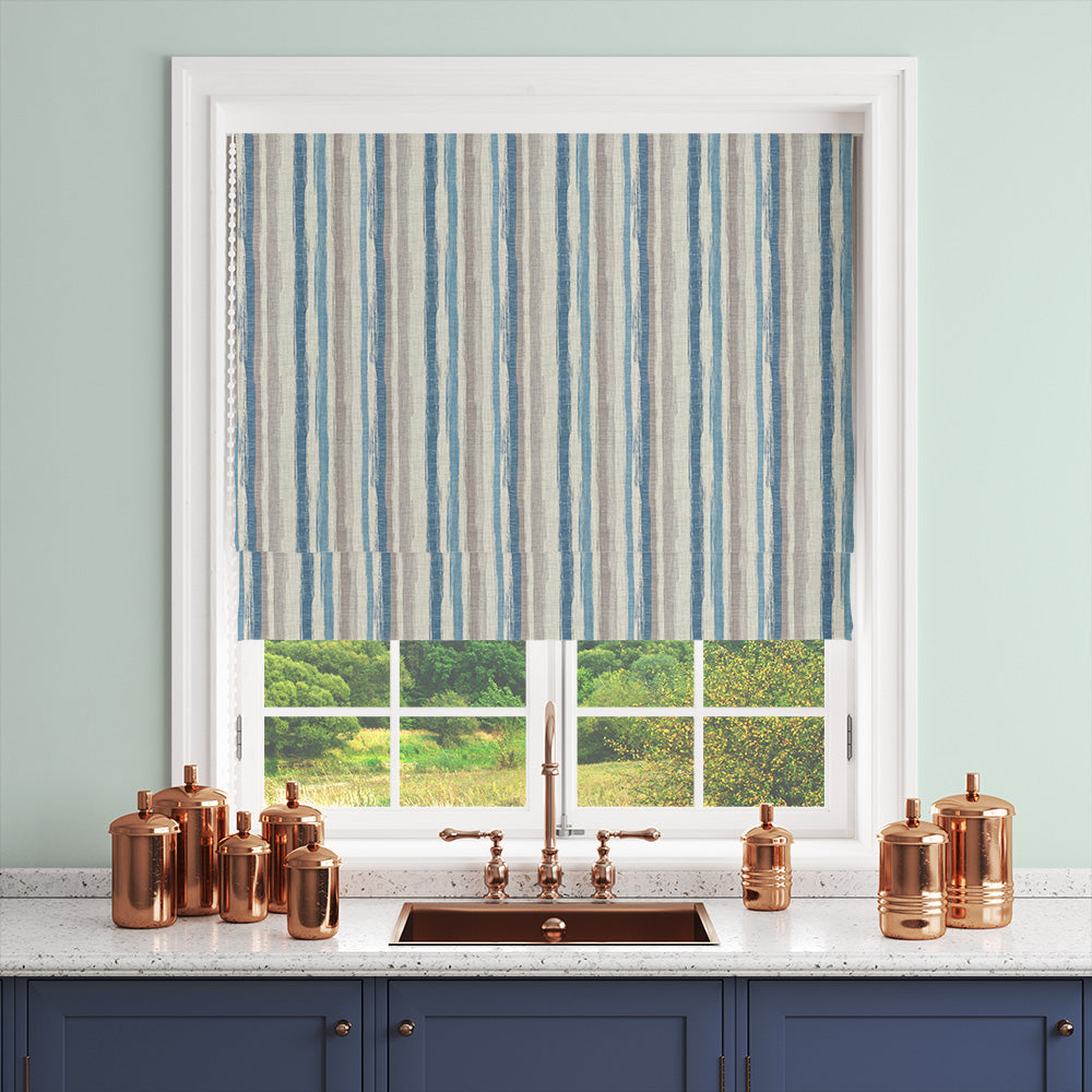 Striped curtain fabric in cooler blue palette styled as a blind in kitchen