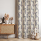 Baku Paisley Linen curtain fabric in navy blue, styled as elegant draped curtains in a sophisticated interior.