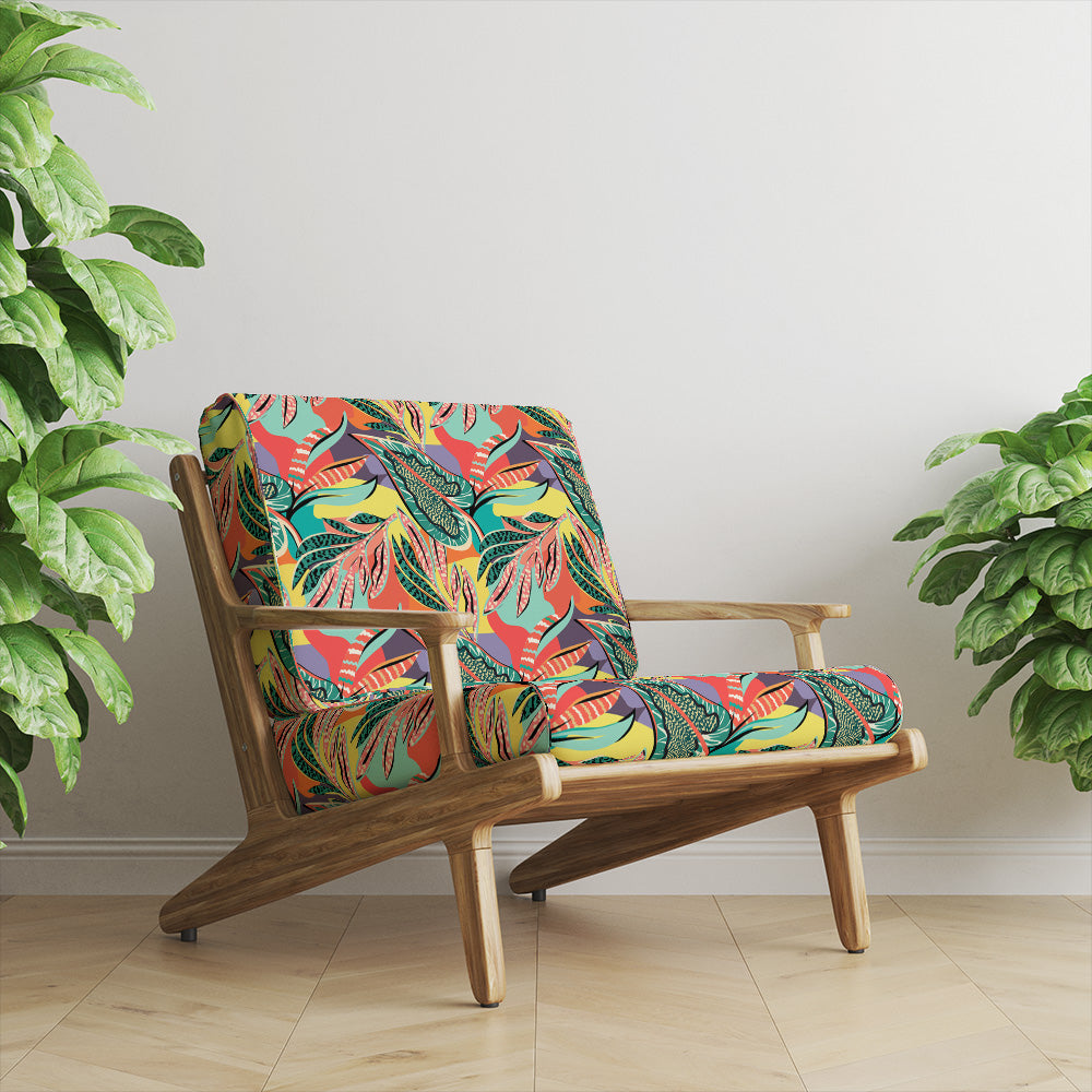 Bermuda Crib 5 tropical velvet shown on a wooden lounge chair with vibrant botanical upholstery