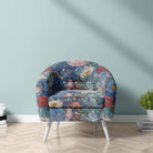 Canterbury Flower Blue velvet upholstery fabric shown on a chair featuring painterly blossoms in navy, blush, and teal tones with a rich blue backdrop