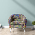 Canterbury Flower Iris velvet fabric on upholstered armchair showing intricate multicoloured floral detailing and dark green tones
