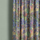Canterbury Flower Iris velvet curtain fabric draped to show botanical floral design in jewel tones, inspired by stained glass windows