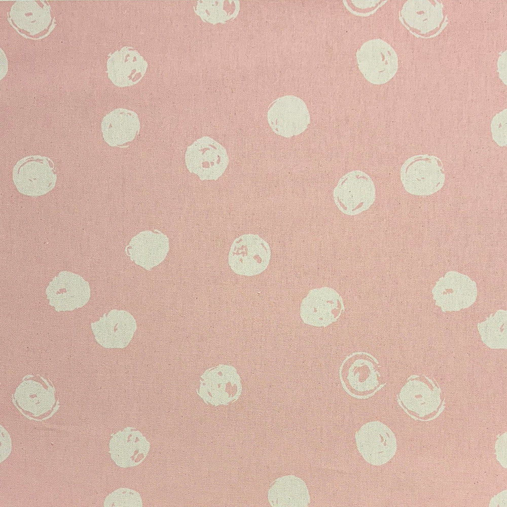 Chiese blush spotted curtain fabric with a modern polka dot print, ideal for soft furnishings.