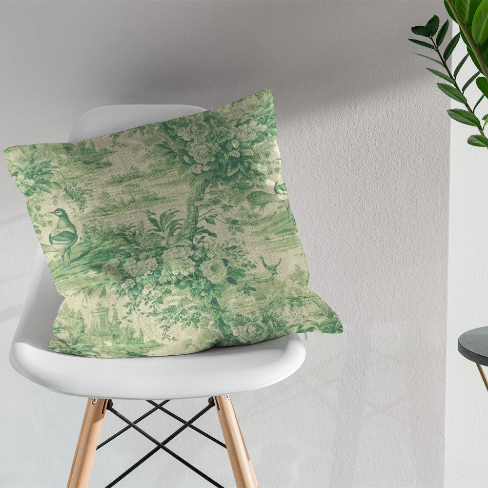 Colmar green bird and floral toile fabric shown on a tailored scatter cushion