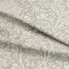 Close up image of Cynara Flower Fabric, a beautiful floral patterned textile perfect for home decor and fashion projects