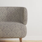 Chair upholstered in Driftwood Leaf Dove Grey fabric, perfect for interiors.