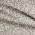 Folded Driftwood Leaf Natural fabric, highlighting its intricate leaf pattern.