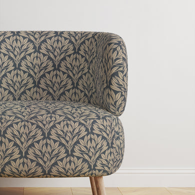 Chair upholstered in Driftwood Leaf Navy fabric, adding sophistication.