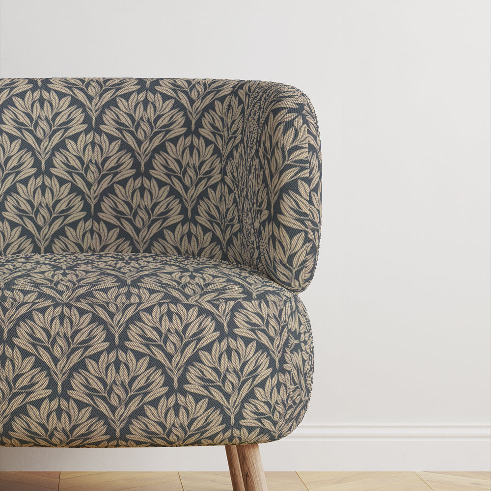 Chair upholstered in Driftwood Leaf Navy fabric, adding sophistication.