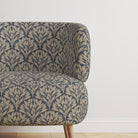 Chair upholstered in Driftwood Leaf Navy fabric, adding sophistication.