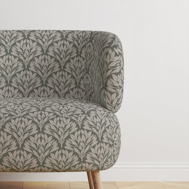 Chair upholstered in Driftwood Leaf Sage fabric, a refined upholstery choice.