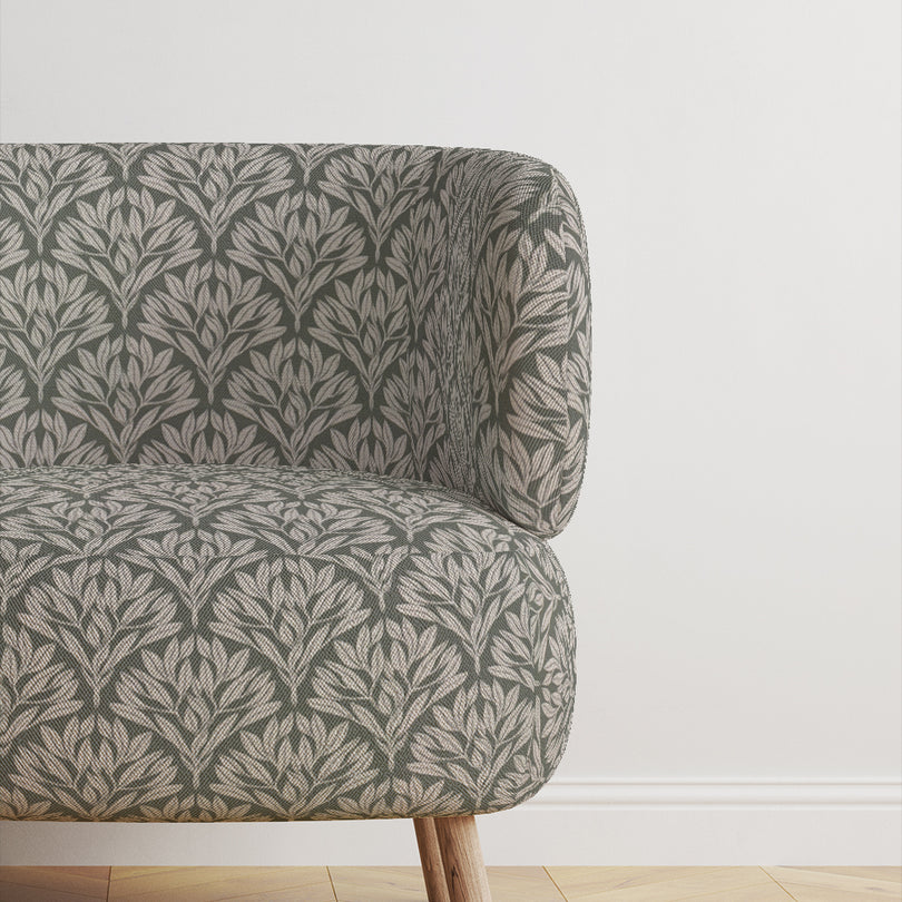 Chair upholstered in Driftwood Leaf Sage fabric, a refined upholstery choice.