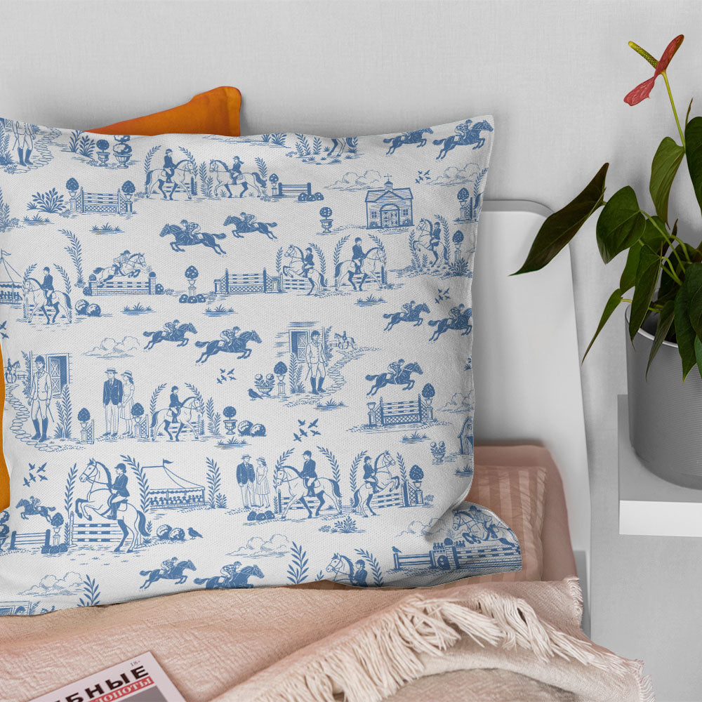 Blue and white equestrian curtain fabric styled as a country cushion with crisp toile detail