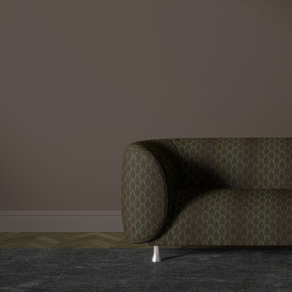Feathered Velvet ebony gold upholstery fabric shown on a sofa with feather pattern