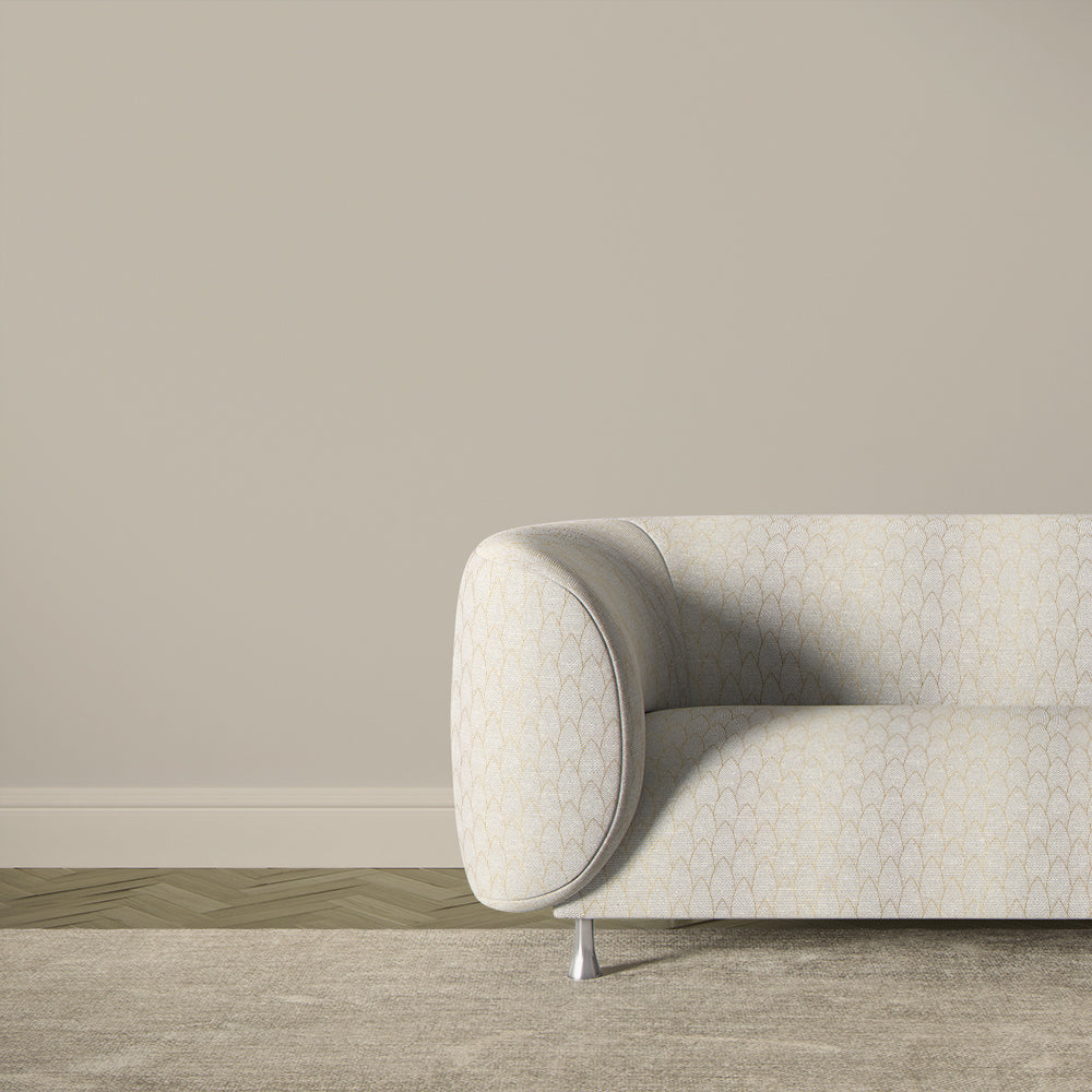 Feathered Velvet gold fire retardant upholstery fabric displayed on a sofa