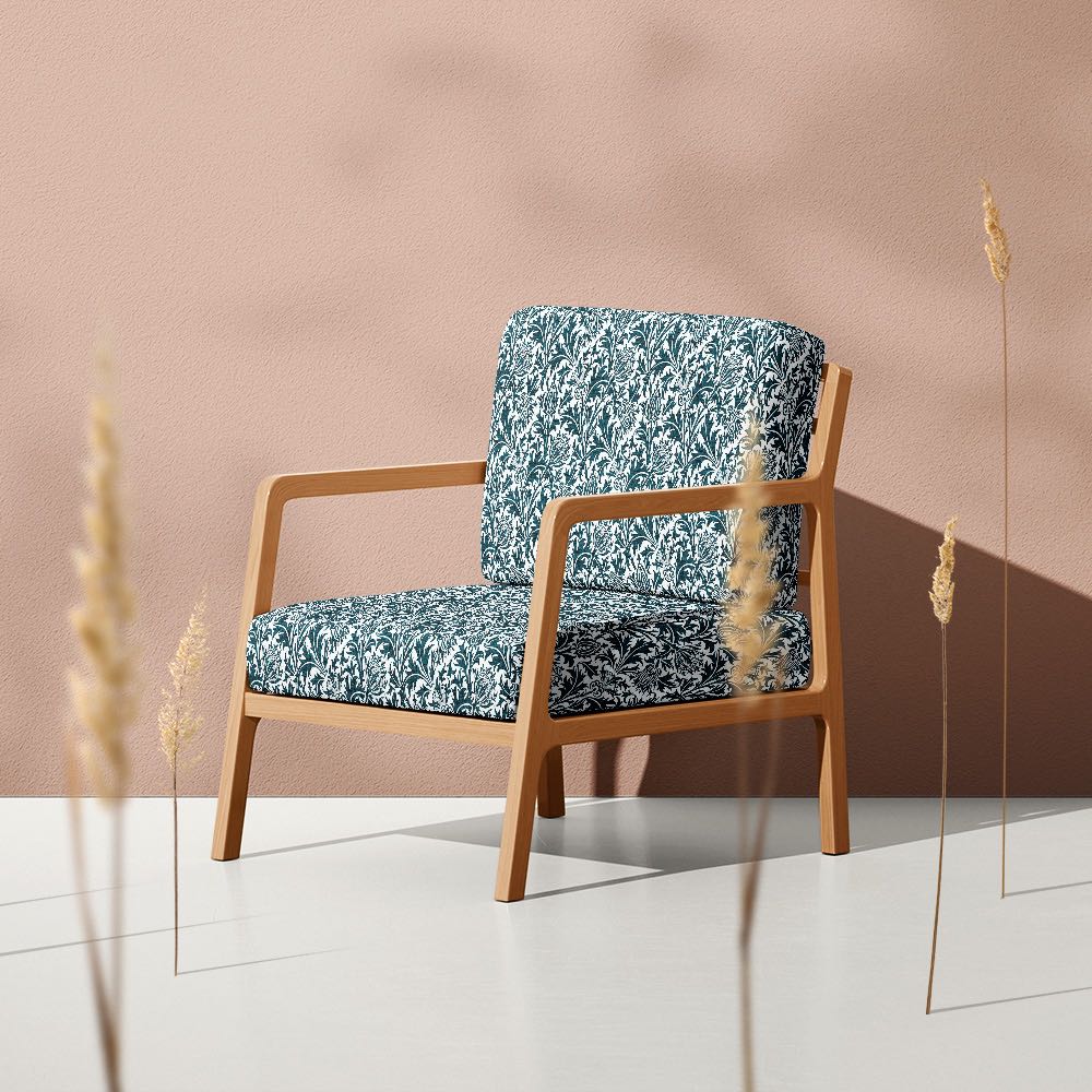 Deep teal Feuille Crib 5 velvet upholstery fabric on a statement armchair