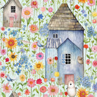 Folded Folk House linen fabric in Duck Egg showing illustrated cottages and wildflowers.