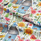 Close-up of Folk House White linen blend fabric showing hand-drawn houses and flowers.