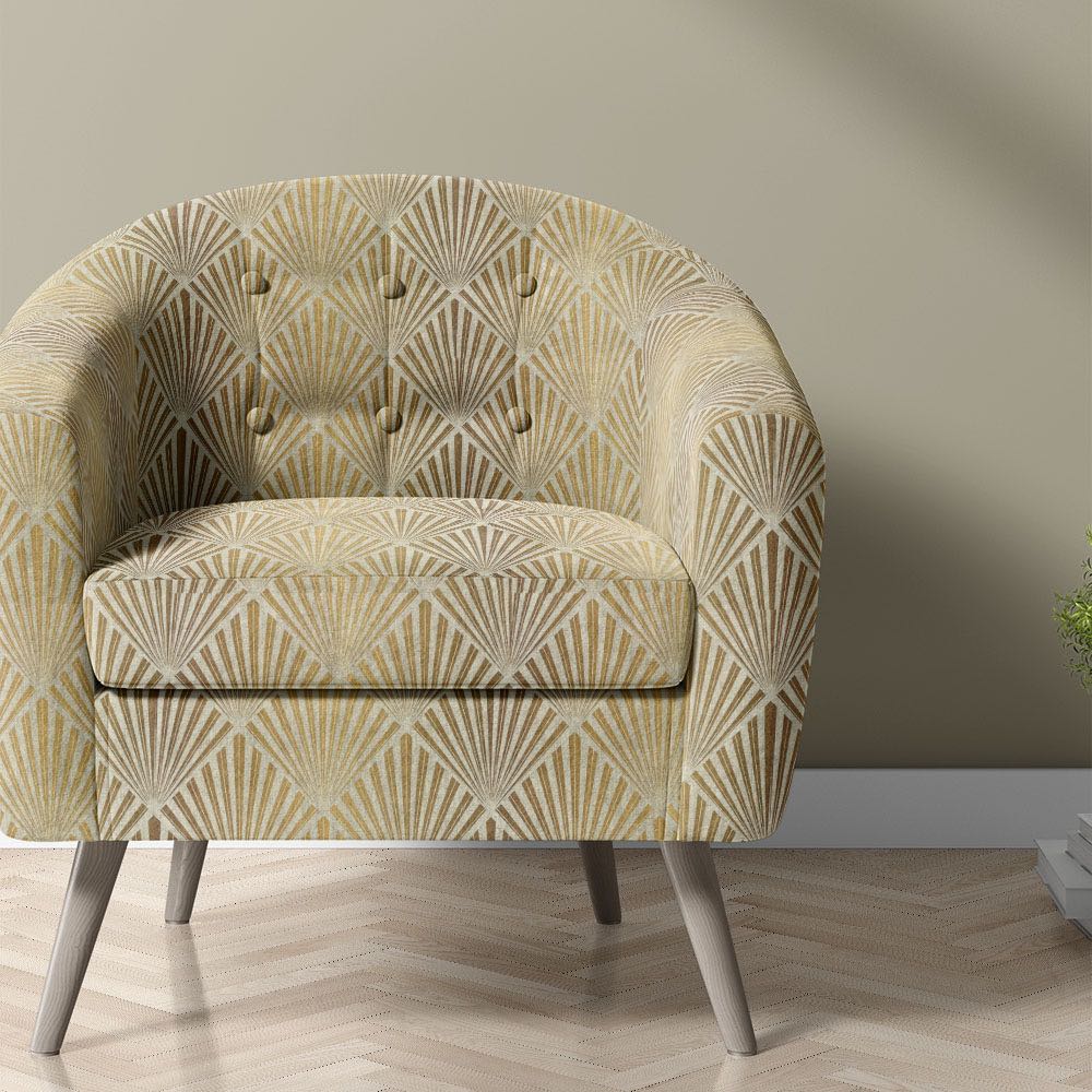 art deco upholstery fabric in gold and neutral tones used on modern accent chair
