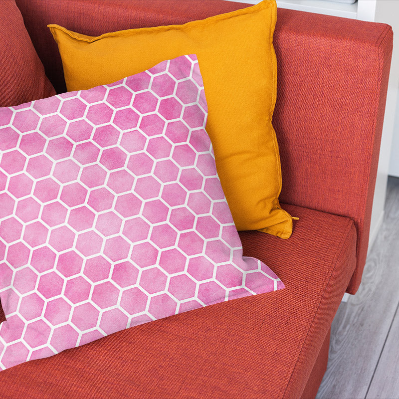 Pink geometric fabric displayed as a honeycomb print cushion for colourful interiors