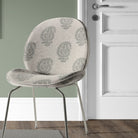 Kaveri Paisley Fennel upholstery fabric used on a chair, showcasing its elegant green-toned pattern