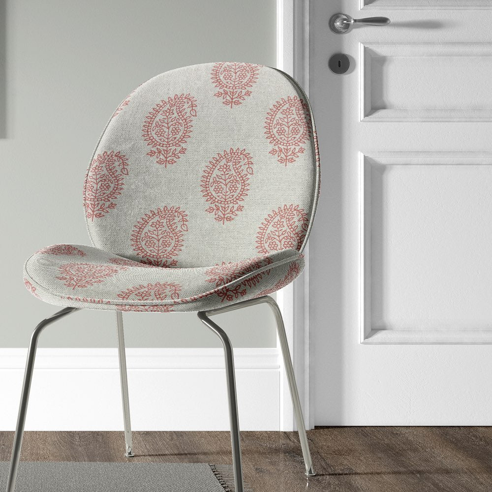 Kaveri Paisley Henna upholstery fabric on a chair, highlighting its soft texture and vintage-inspired paisley design