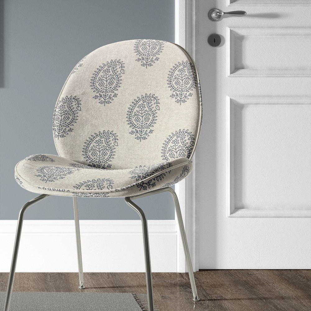 Kaveri Paisley Navy upholstery fabric used on a chair, adding a bold yet sophisticated touch to upholstery projects