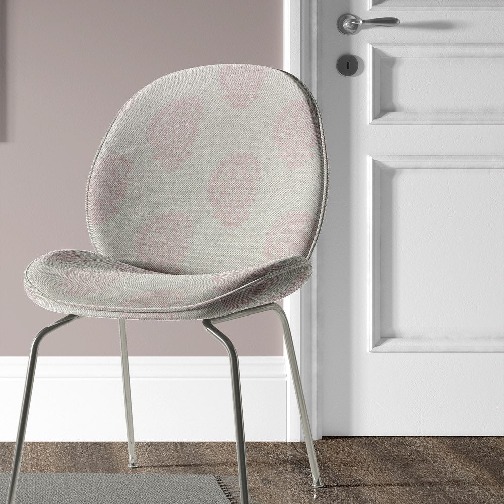 Kaveri Paisley Pink upholstery fabric used on a chair, showcasing the intricate pattern and comfortable texture