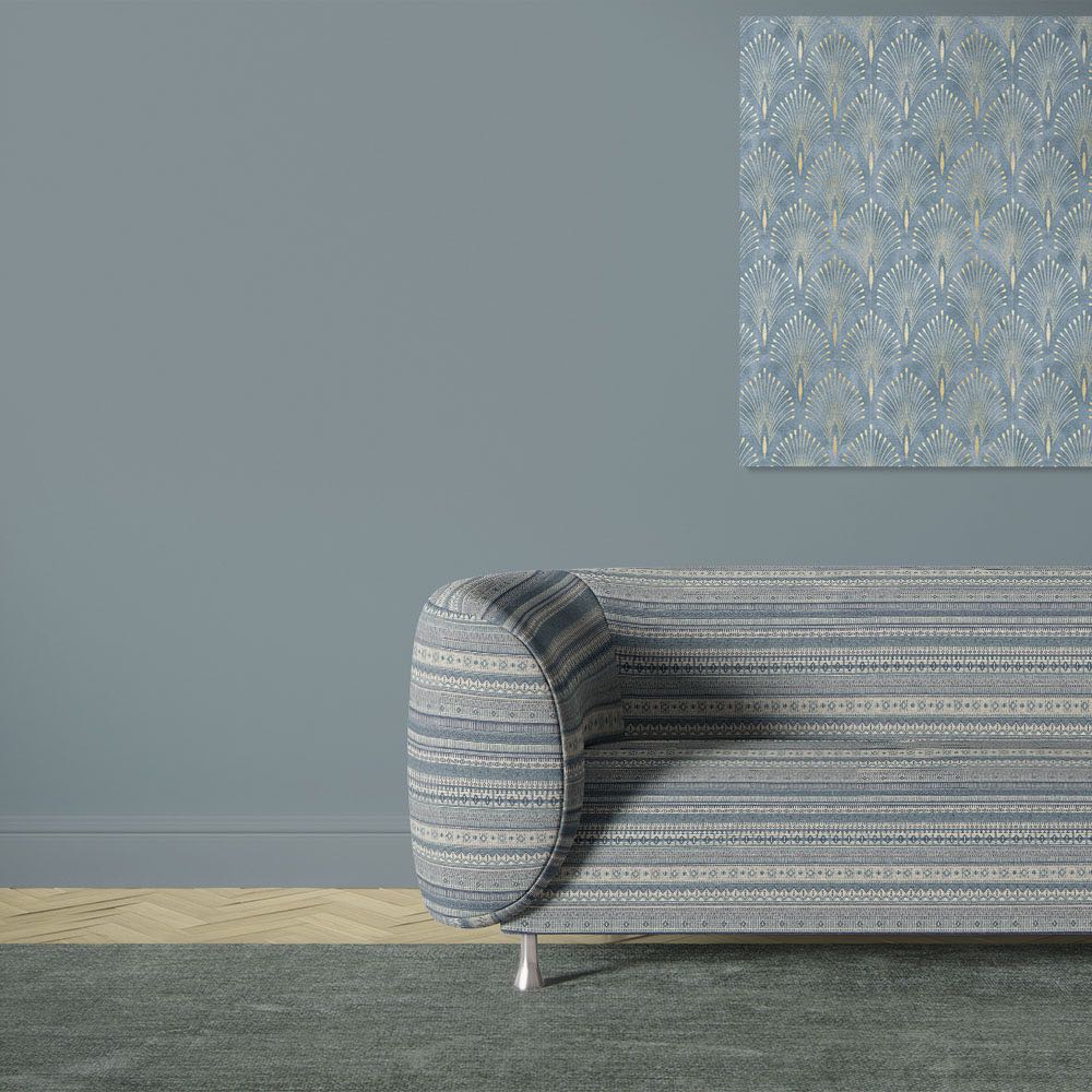 Khenifra Sapphire railroaded velvet upholstery fabric shown on a sofa with horizontal stripe layout