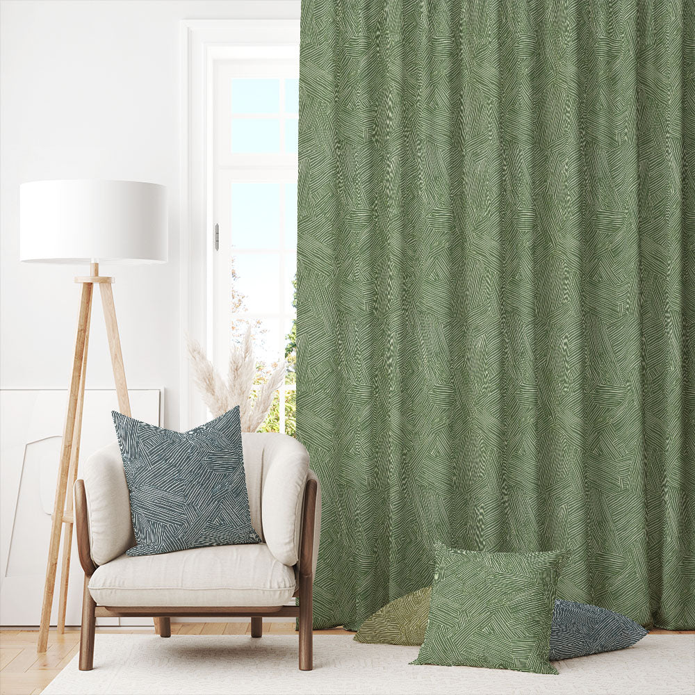 Laguna Green curtain fabric shown in a bright space with coordinating cushions