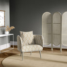 Lambourne Natural leaf pattern upholstery fabric on a cushioned accent chair