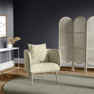 Lambourne Ochre leaf print upholstery fabric on an upholstered armchair