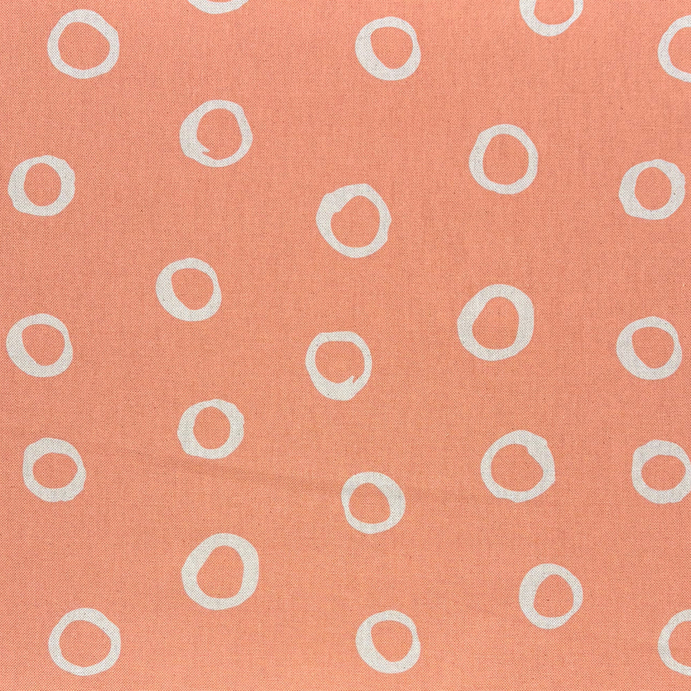 Limentra Peach Spotted Curtain Fabric – a soft orange polka dot fabric ideal for warm, inviting décor.