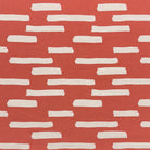 Liri Red curtain fabric with a bold artistic print, perfect for adding warmth to interiors.